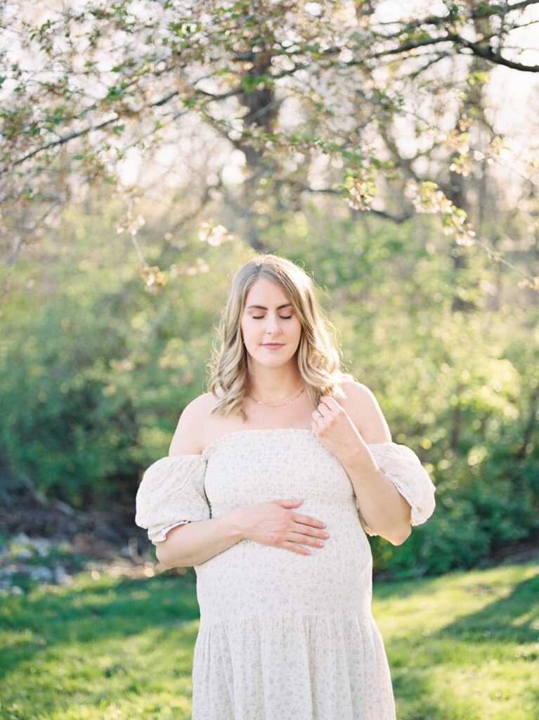 Portrait by Franklin Maternity Photographer Courtney Houk of pregnant mother as she closes her eyes with her hand on top of her bump 
