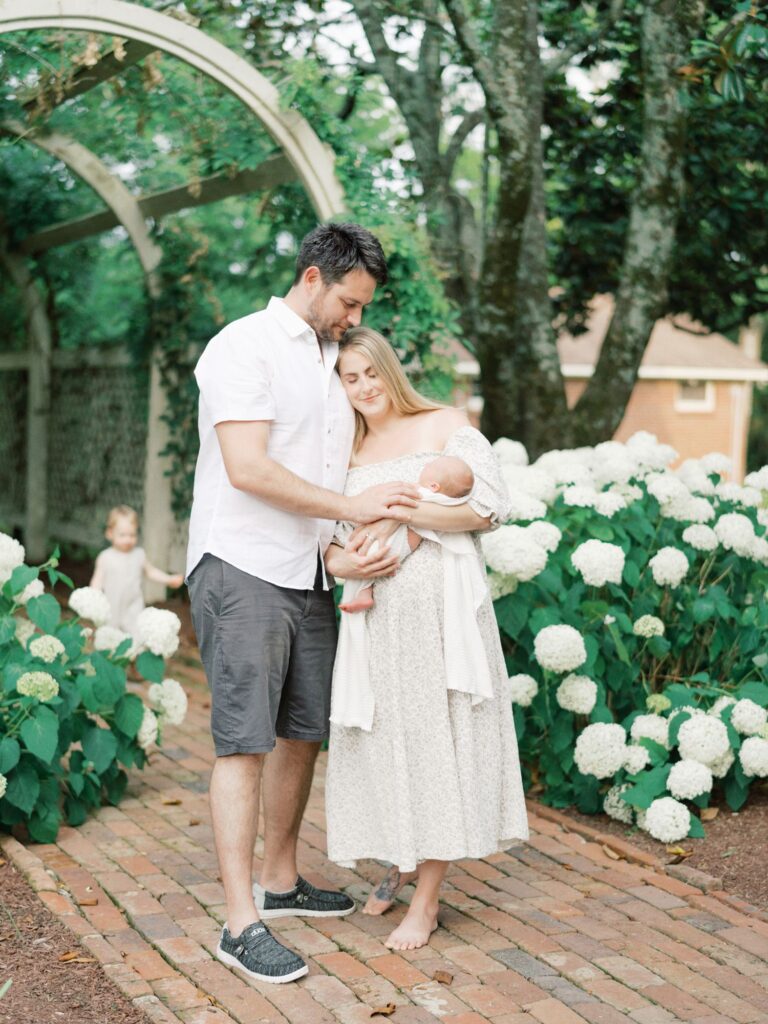 Courtney Houk Photography captures Nashville outdoor newborn photos of a mom, dad, baby boy, and 2 year old toddler.