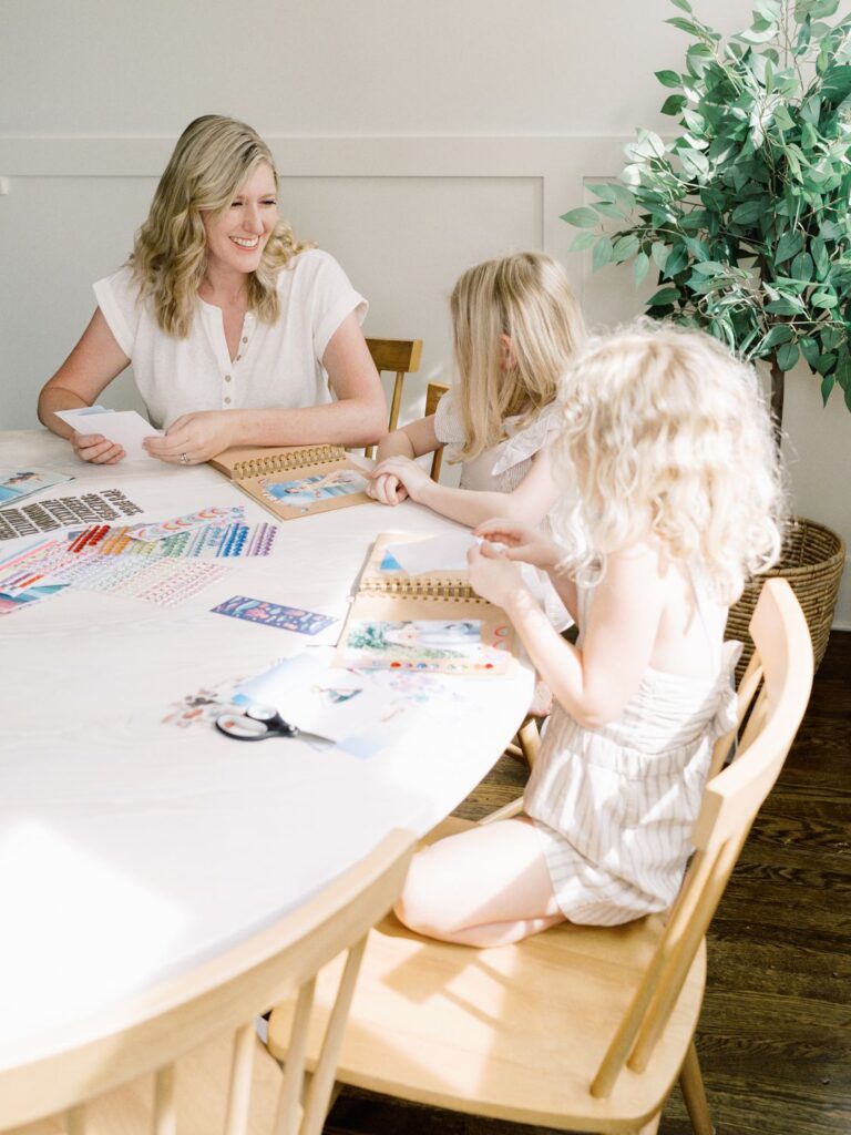 Courtney Houk Photography captures photo of mom doing scrapbooking craft with two daughter in this Franklin TN in-home family session