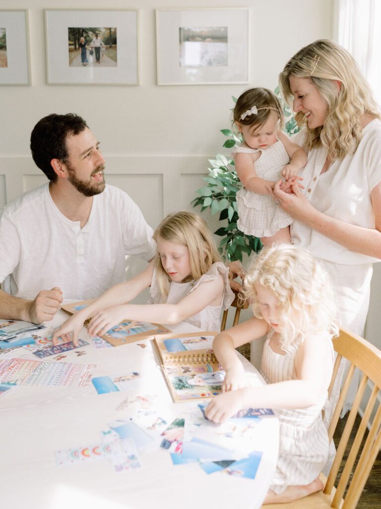 Franklin TN in-home family session features family of five doing a scrapbook craft at dining room table
