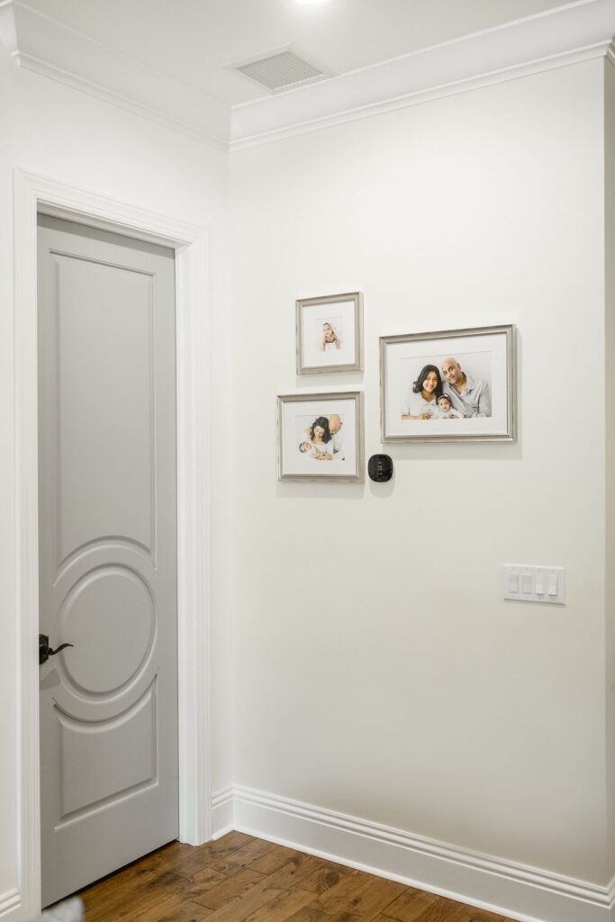 a white door with pictures on the wall