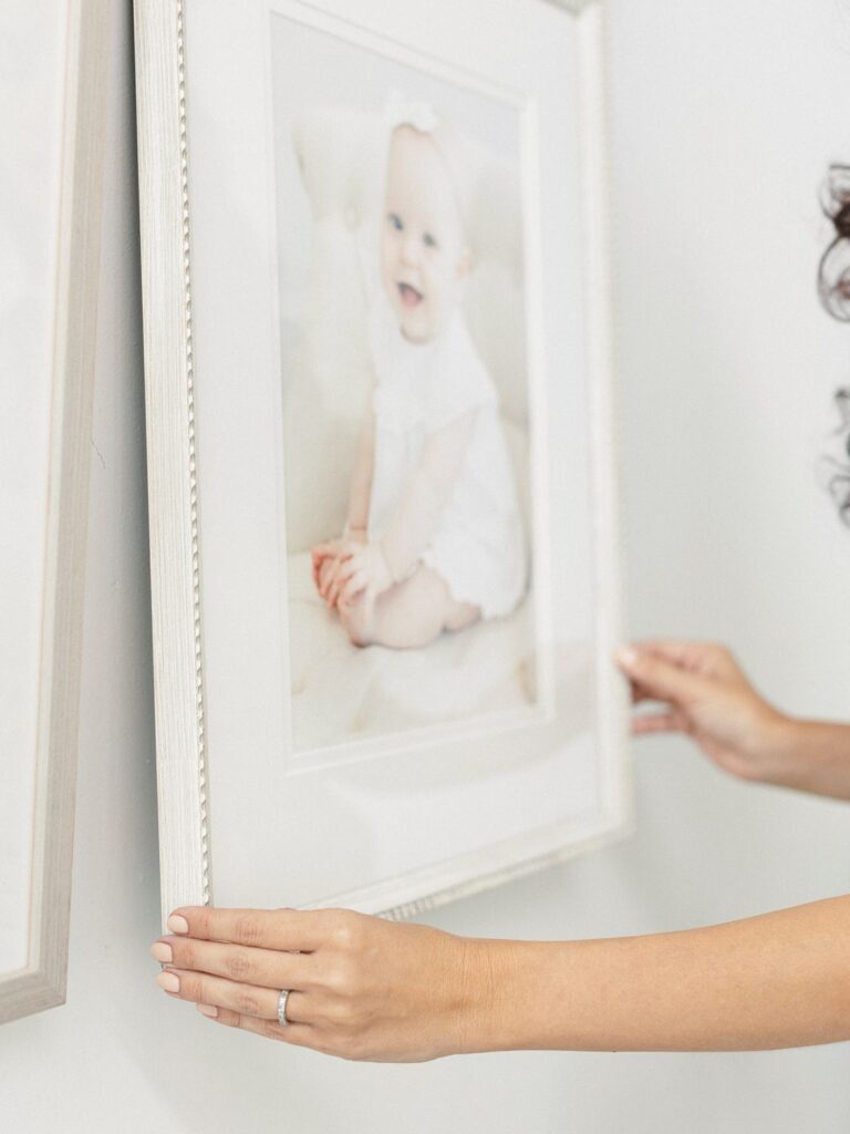 a woman holding a picture of a baby