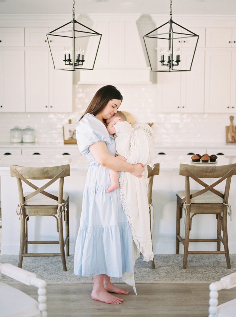 Nashville newborn photographer Courtney Houk captures a photo of a mama snuggling her 6 month old baby boy 