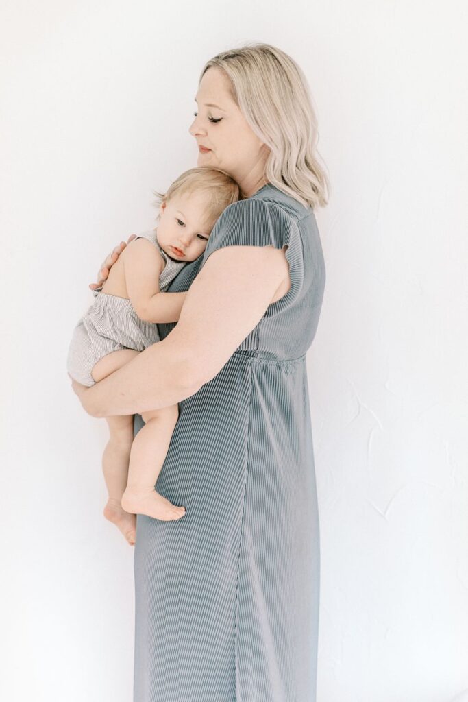 Nashville motherhood photographer Courtney Houk captures a photo of a mama holding her one year old baby boy to her chest