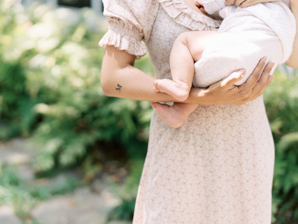 This detail image is of a mama cradling a 3 month old baby boy. It is captured by Franklin TN motherhood photographer Courtney Houk. 