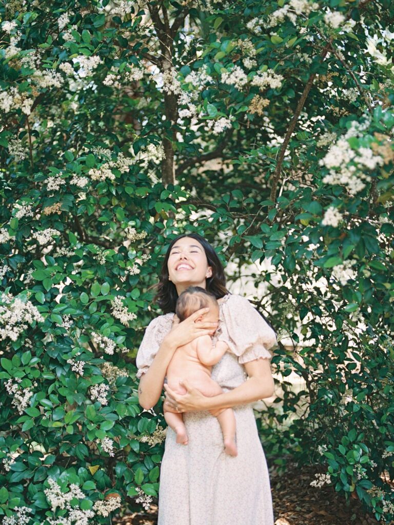 Courtney Houk is a Franklin TN motherhood photographer who captured a photos of a 3 month old baby on mamas chest while she looks up and smiles