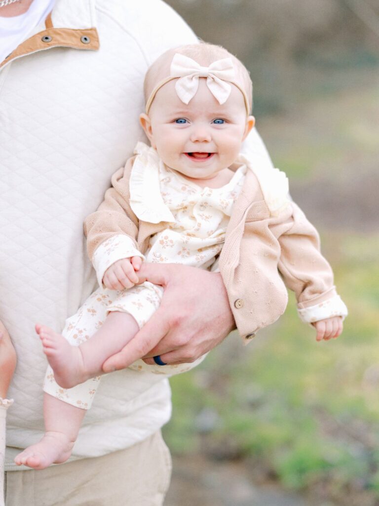 a baby in her dad's arms